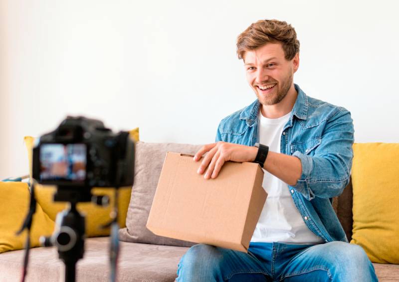 an influencer shooting himself as he unboxes a product